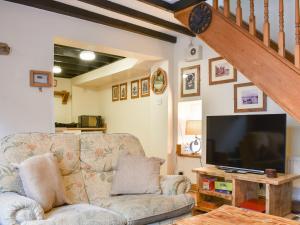 a living room with a couch and a flat screen tv at Awd Tuts in Whitby