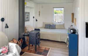 a bedroom with a bed and a stove in it at Lurifax in Hejls