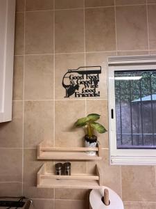 a kitchen with a window and a plant on a wall at Stylish Villa Benalmádena Beach in Benalmádena +96 photos