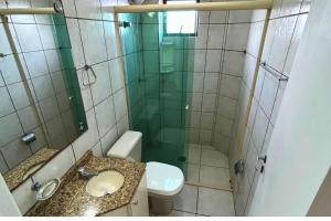 a bathroom with a shower and a toilet and a sink at Apartamento com vista mar e excelente localização in Bombinhas +7 photos