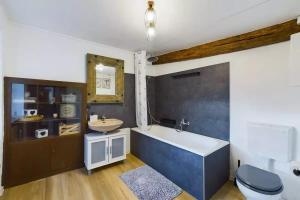 a bathroom with a tub and a sink and a toilet at Haus Ewald in Enkirch