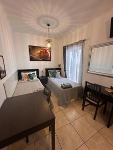 a bedroom with a bed and a table and a desk at Stylish Villa Benalmádena Beach in Benalmádena