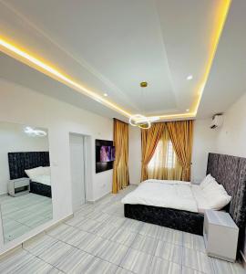 a bedroom with a bed and a large window at SolarisApartment in Abuja