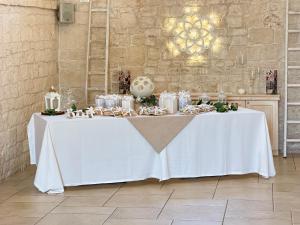 a table with a white table cloth on it at Masseria Paretano in Santa Lucia