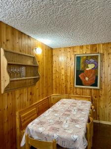 a bedroom with a bed in a wooden room at Dimaro-Folgarida Apartment in Monclassico +18 photos