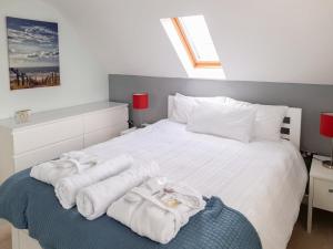 a bedroom with a bed with towels on it at Gorsehill House in Poole