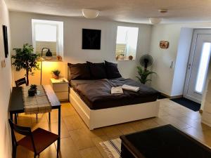 a bedroom with a bed and a table in it at Ferien im Schwarzwald Dörlinbach in Dörlinbach