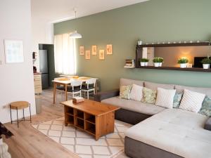 a living room with a couch and a table at Cosy Hideaway near Kiserdo in Balatonfüred