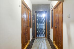 a hallway with a door with a wrought iron gate at Hotel O RR in Hyderabad