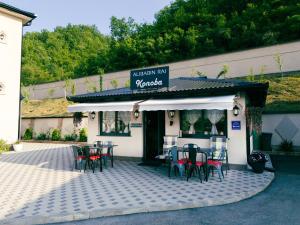 a restaurant with tables and chairs in front of it at Hotel Alibabin Raj in Konjic