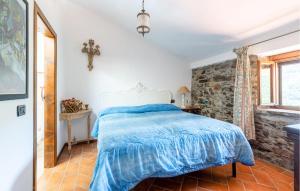 a bedroom with a bed and a stone wall at Casa Lina in Comano