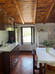 a kitchen with a table and a window in it at Dimora La Casetta in Fradegola +27 photos