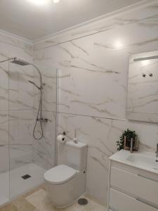 a white bathroom with a toilet and a sink at TOWNHOUSE 1 minute walk to Villamartin plaza in Villamartin