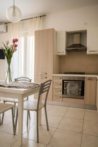 a kitchen with a table and chairs and a stove at Casa Stella in Crotone