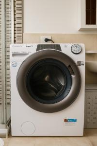 a washing machine with a door on top of it at Casa Stella in Crotone