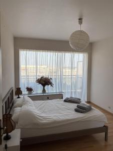 a bedroom with a large bed in front of a window at Cosy apartment near Zaventem Airport in Brussels