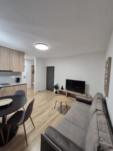 a living room with a couch and a table at Lendas Apartments & Rooms in Baška Voda
