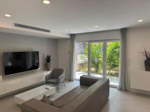 a living room with a couch and a flat screen tv at FRANE-APART - Čiovo in Trogir +37 photos