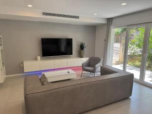a living room with a couch and a tv at FRANE-APART - Čiovo in Trogir