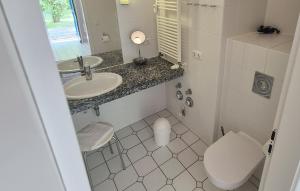 a small bathroom with a toilet and a sink at Ferienwohnung Sonnenwiese in Wittenbeck +7 photos