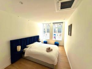 a bedroom with a bed with a teddy bear on it at Loft 250 m2 Toit Terrasse Parking Netflix in Douai