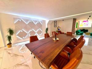a dining room with a wooden table and chairs at Loft 250 m2 Toit Terrasse Parking Netflix in Douai