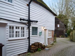 a house with a cross on the side of it at Rose Cottage in Bethersden