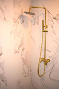 a shower in a bathroom with a marble wall at Queen of Durmitor in Žabljak