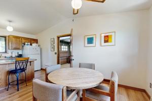 a kitchen and dining room with a table and chairs at Bayside Retreat in Netarts