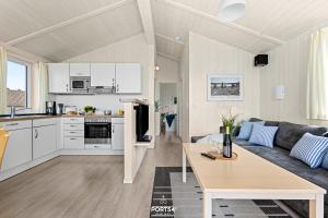 a kitchen and living room with a couch and a table at Ferienhaus Harzliebe - Sankt Andreasberg im Harz in Sankt Andreasberg