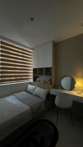 a bedroom with a bed and a desk with a mirror at Minh Anh Apartment 2 in Thôn Văn Dương +2 photos