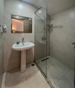 a bathroom with a sink and a glass shower at Club Palm Garden Keskin Hotel in Marmaris