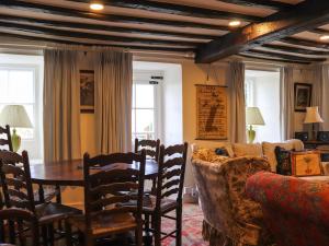 a living room with a table and a couch at Bryn Hyfryd in Harlech