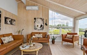 a living room with two couches and a table at Amazing Home In Sjølund With Kitchen in Sjølund