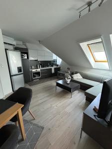 a living room with a couch and a table at Golden on the 3rd floor in Nagykanizsa