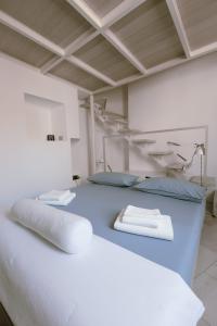 a room with a bed with two pillows on it at Il Giardino della Giudecca Trani in Trani