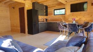 a living room with a couch and a table at Cozy Cottage Wild Freedom in Didi Ateni +13 photos