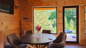 a dining room with a table and chairs and a window at Cozy Cottage Wild Freedom in Didi Ateni