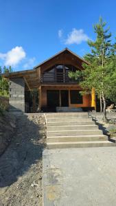 a house with some stairs in front of it at Cozy Cottage Wild Freedom in Didi Ateni
