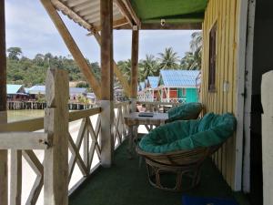 a porch with chairs and a table on a building at SokSan Seaview Cottage in Koh Rong Island