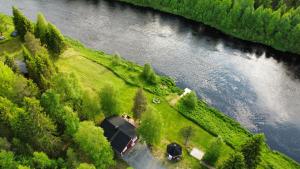 an aerial view of a house next to a river at Villa Jokiranta in Lapland in Ranua