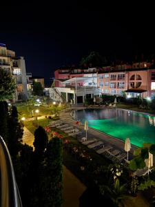 a view of a swimming pool at night at 'Oasis' Ravda Apartment, Nessebar in Ravda