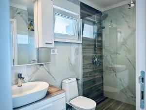 a bathroom with a sink and a toilet and a shower at Villa Moderne MARIA-VIDA Piscine Medugorje 2km Mostar 22km in Međugorje