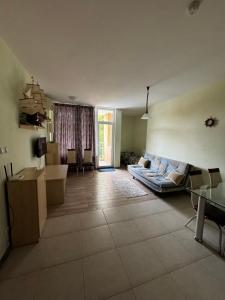 a living room with a couch and a table at 'Oasis' Ravda Apartment, Nessebar in Ravda