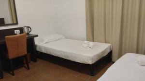 Voodi või voodid majutusasutuse MC Hotel toas
