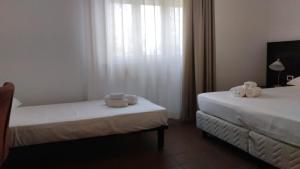 Voodi või voodid majutusasutuse MC Hotel toas