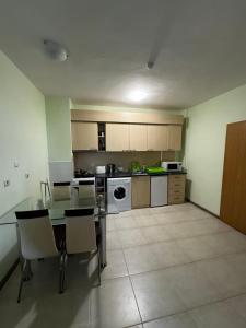 a large kitchen with a table and chairs in it at 'Oasis' Ravda Apartment, Nessebar in Ravda