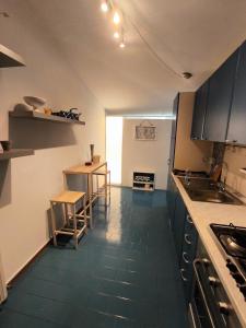 a kitchen with a table and a counter top at Loggia Rossini in Pesaro +5 photos