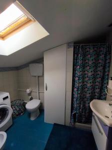 a bathroom with a toilet and a sink and a window at Loggia Rossini in Pesaro