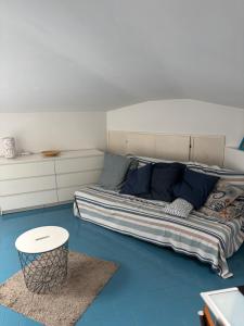 a large bed in a room with blue floors at Loggia Rossini in Pesaro